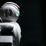 Close-up of a futuristic robot in a dark studio setting, showcasing innovation and technology.